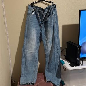 Blue jeans with black flame detail in the pockets